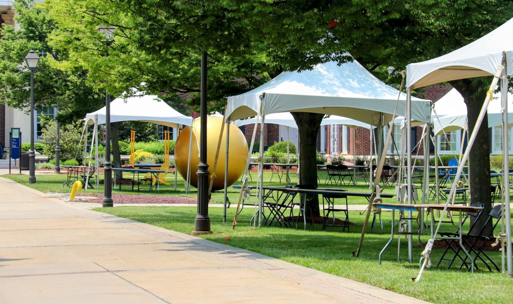 White,Peak,Tents,Are,Set,Up,On,A,Green,Lawn